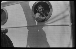 Image: Man leaning out of porthole